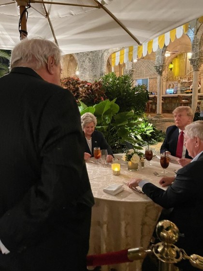 Alan Stone standing on a palm lined walkway at Mar-a-Lago