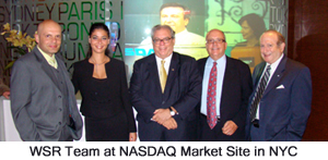 Five members of the WallStreet Research team standing together at the NASDAQ MarketSite in New York City